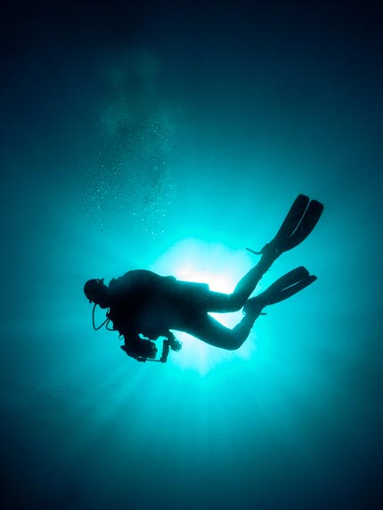 Diver in Silhouette - Batu Puten Pinnacle, Sulawesi, Indonesia
